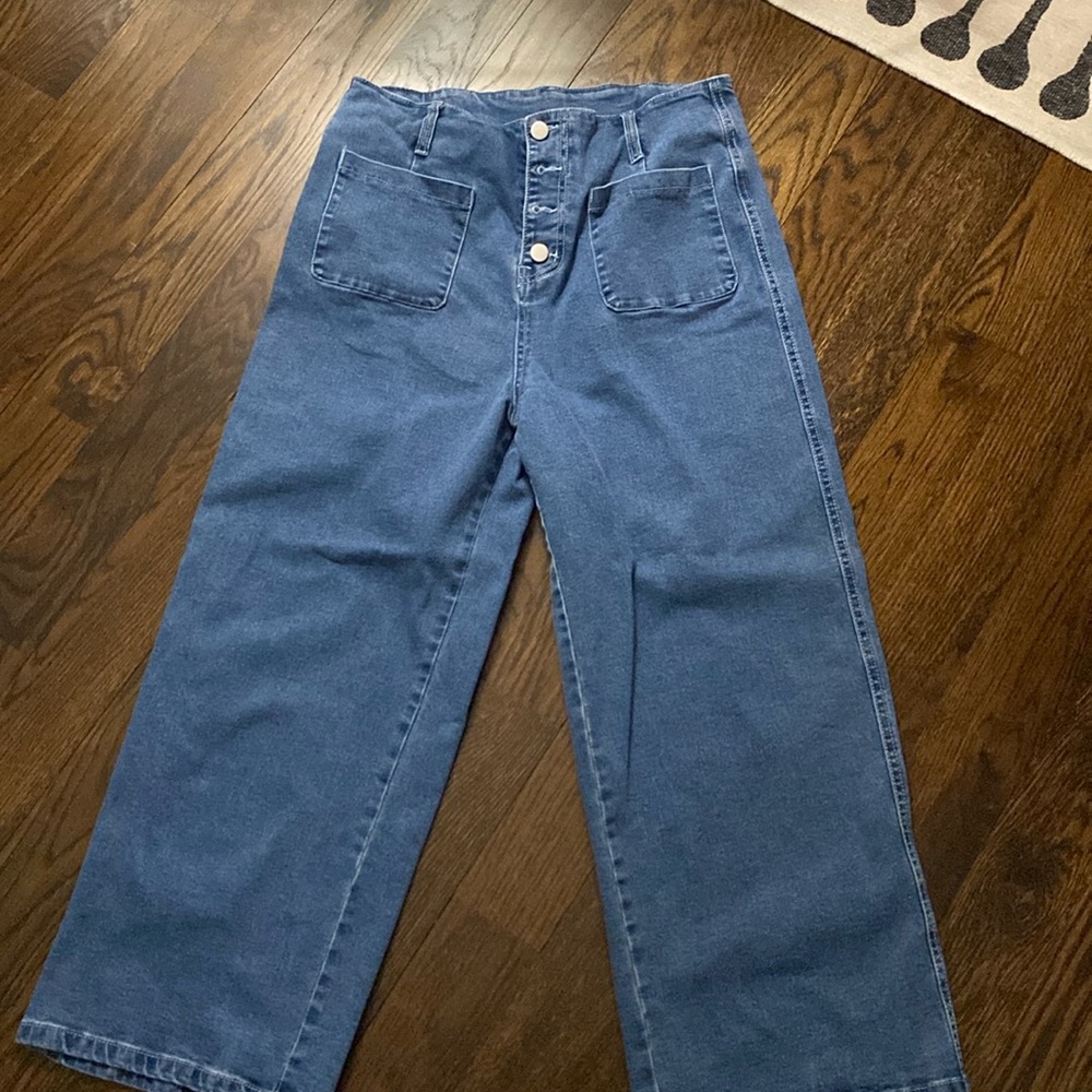 Wide leg - ankle or slightly above jeans with button front.